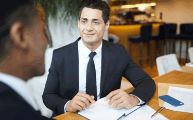 Image of man smiling in a meeting